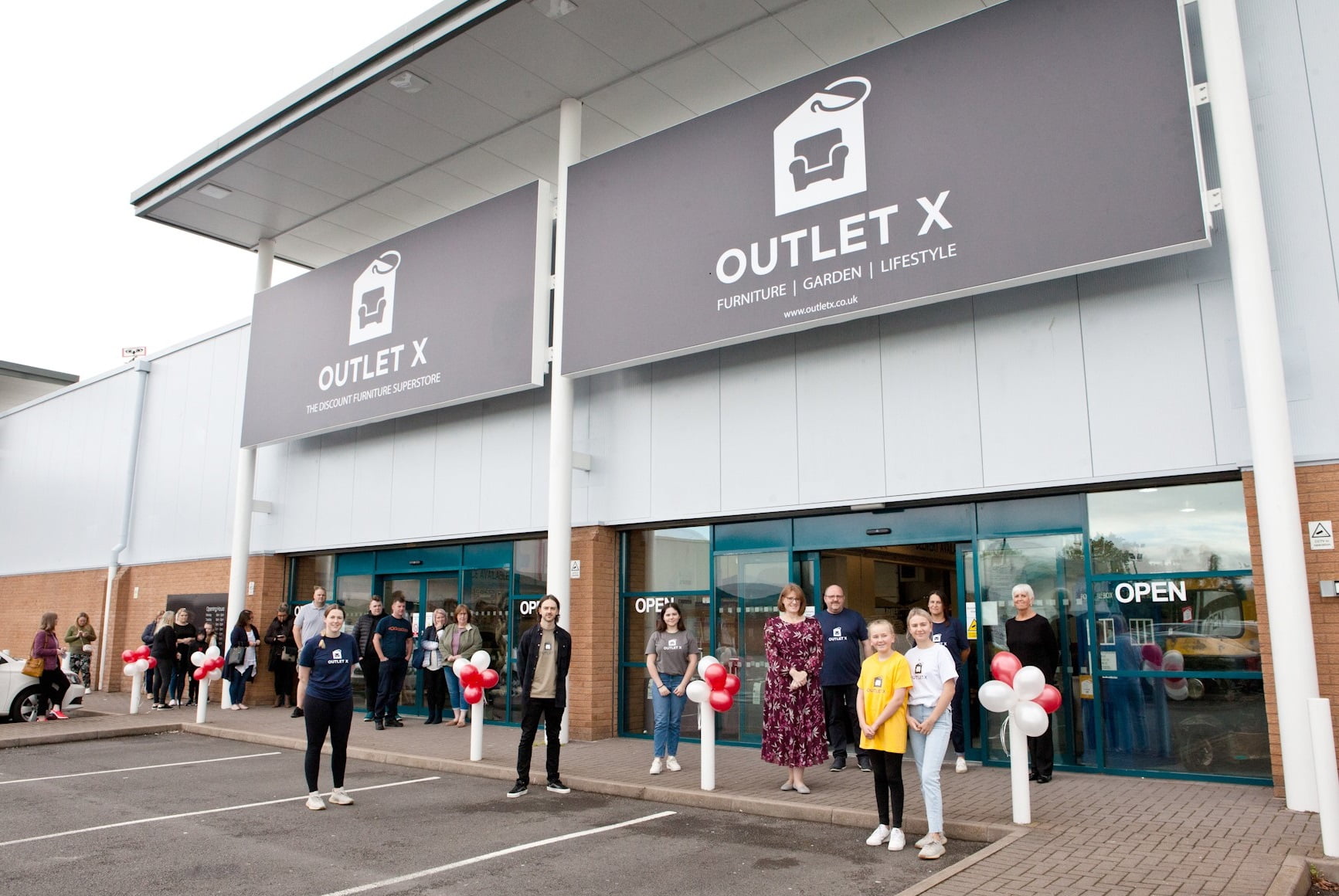 Liz Lowe, Head of Estates at Morris Property (centre in floral dress) with the Outlet X team and shoppers